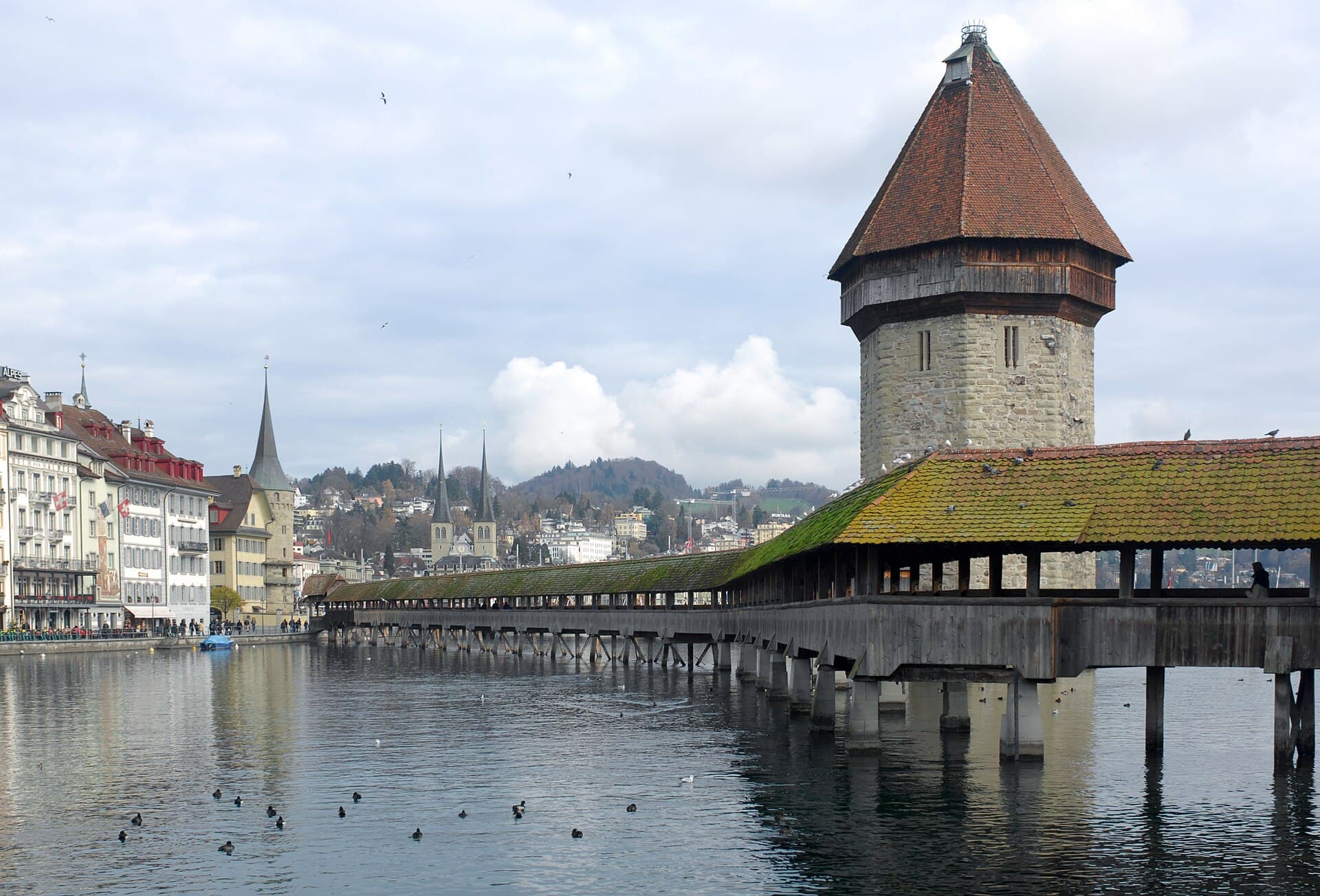 The wooden Chapel Bridge and octagonal Water Tower spanning the Reuss river in Lucerne's old town