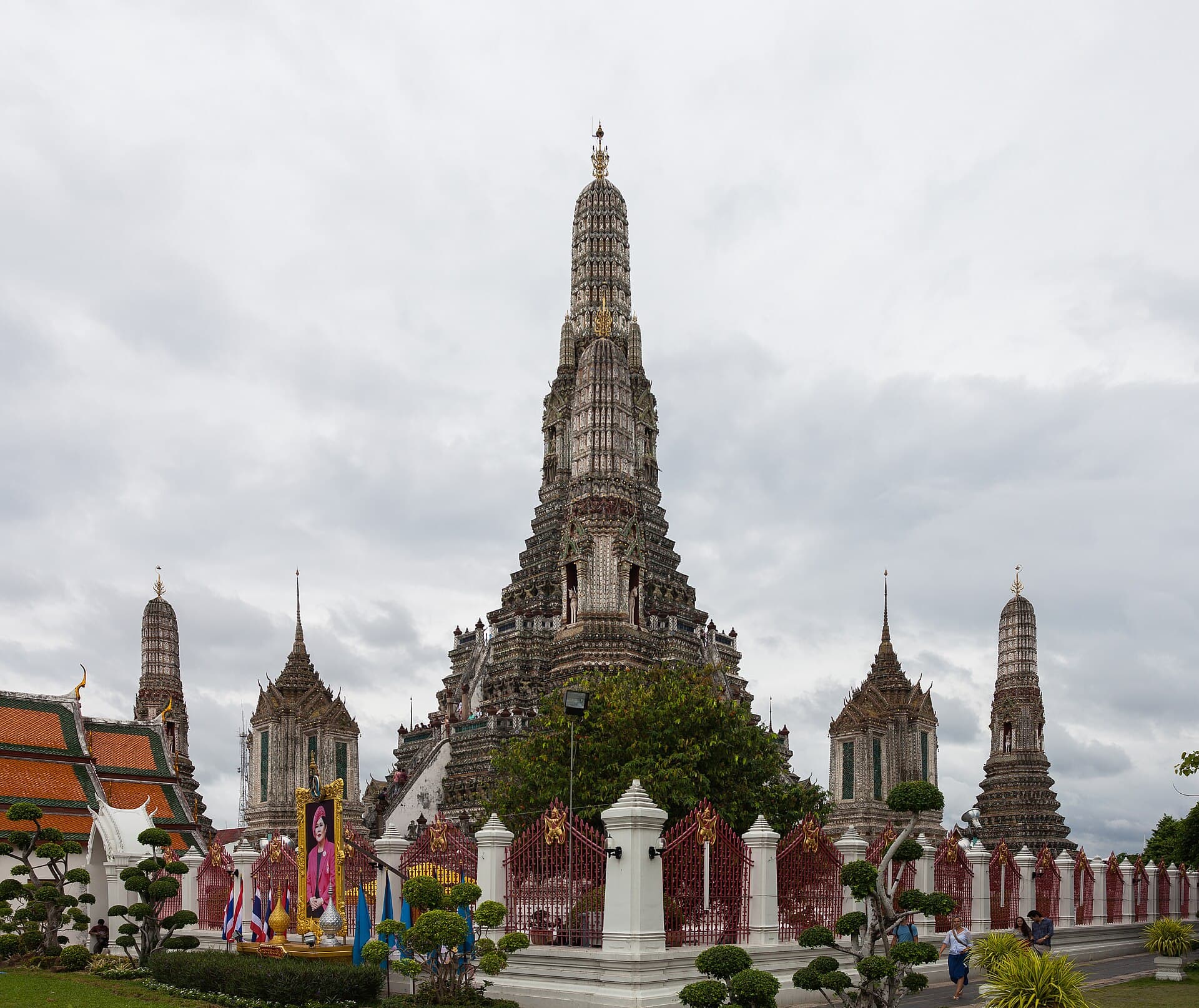 Wat Arun's tall central prang encrusted with porcelain-shard mosaic, flanked by smaller satellite spires